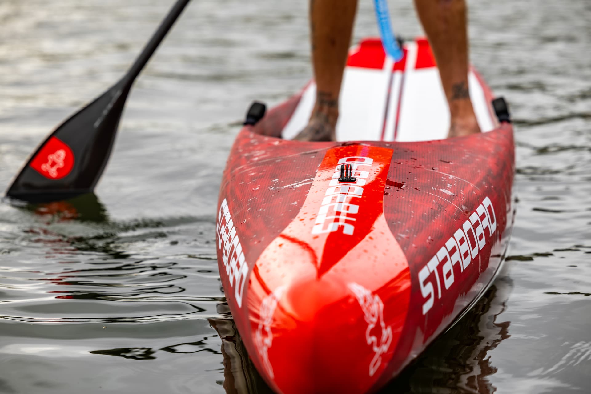 Bow detail of a Starboard race board on the water